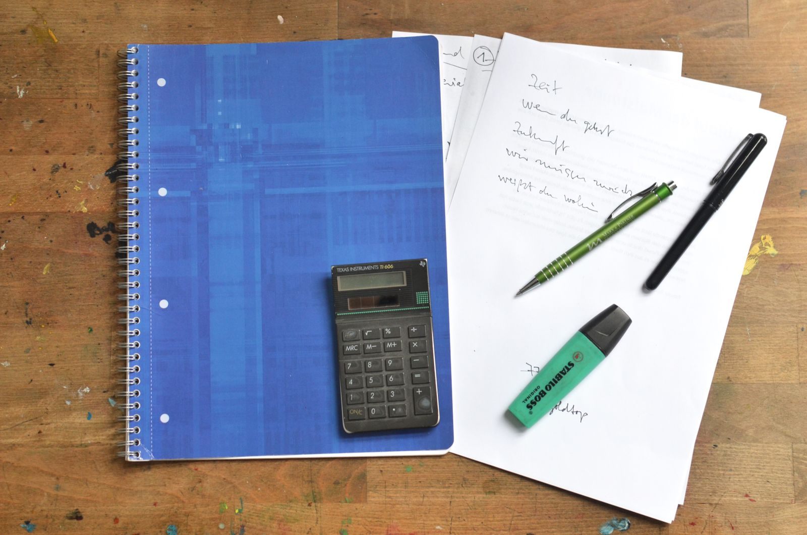 A calculator, notebooks and pens laid out to compare cruise prices 2027